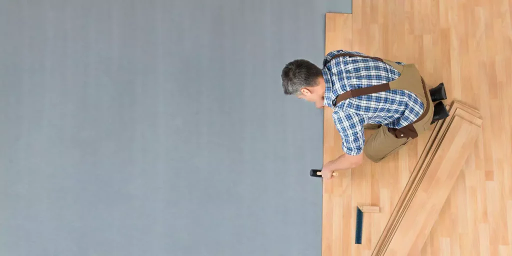 Worker installing laminate | CR Carpet
